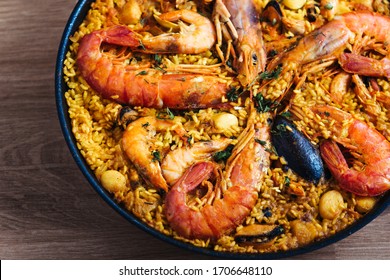 Traditional rice in paella with fish . Typical Spanish. top view