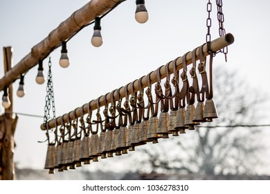 Traditional Ritual Brass Bells Hanging Outside In A Row