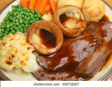 Traditional Roast Beef Dinner With Yorkshire Pudding, Vegetables And Gravy.