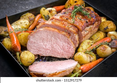 Traditional Roasted Dry Aged Veal Tenderloin With Carrots And Potatoes Offered As Closeup On A Metal Tray 