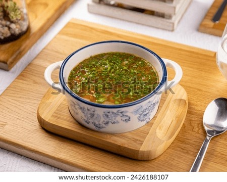 Traditional Romanian chorba soup with vegetables and beef cubes