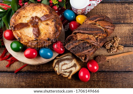 Traditional Romanian Easter table with cozonac and pasca meaning Sweetbread and Matzo an unleavened flatbread that is part of Jewish cuisine and forms an integral element of the Passover. Happy Easter