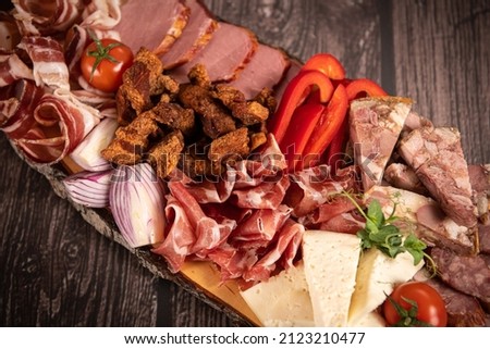 Traditional Romanian food. Close up view of a food plate made of pork meat against a wooden background.