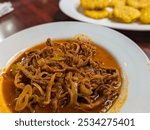 Traditional Ropa Vieja with Tostones Patacones in the Background in Panama