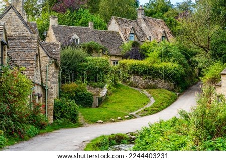 Traditional row of stone cottage houses on Arlington Row in Bibury village, Gloucestershire, The Cotswolds, England UK
