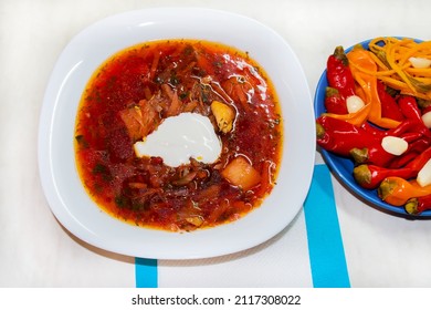 Traditional russian borscht, soup with tomato, meat, carrot, potato, pepper, cabbage and fresh greens, beetroot dish. - Shutterstock ID 2117308022