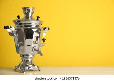 Traditional Russian samovar on yellow background. Space for text