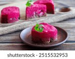 Traditional Russian sandwiches with beetroot salad, pickled onions and salted herring. Bruschetta with beetroot and herring. Canapes with herring under a fur coat. Wooden cutting board background.