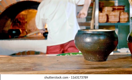 Traditional Russian Stove With Cooking Food On Wood In Crock. Pot In Fireplace. Russian Cuisine Concept