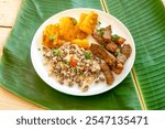 Traditional rustic tropical Brazilian dish, sun-dried beef with green beans, cassava, biquinho pepper. Creative rustic photography