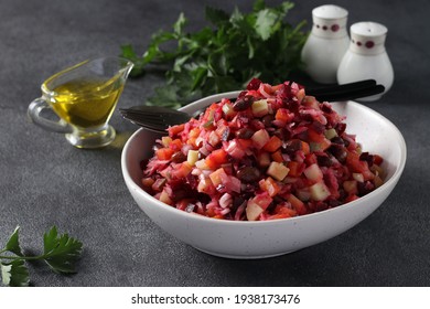 Traditional salad Vinaigrette of beets, potatoes, carrots, beans, pickles, onions and vegetable oil on gray background. Vegetarian food