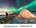 Traditional Sami reindeer-skin tents (lappish yurts) in Troms region of Norway .The polar lights in Norway .