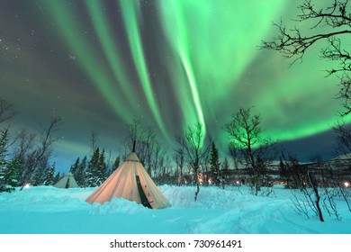 Traditional Sami reindeer-skin tents (lappish yurts) in Troms region of Norway .The polar lights in Norway 