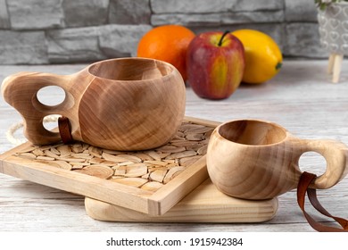 Traditional Sami Wooden Cups On A Wooden Table, On Wooden Planks Stands. Kuksa. Finnish Wooden Cups. Finnish Culture.