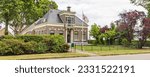 Traditional saxon farm house with Drenthe flag in pictoresque rural hamlet Westenesch municipality Emmen at Hondsrug in Drenthe province The Netherlands