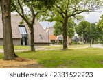 Traditional saxon farm house with Drenthe flag in pictoresque rural hamlet Westenesch municipality Emmen at Hondsrug in Drenthe province The Netherlands