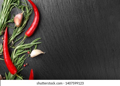 Traditional Seasonings For Meat And Fish Dishes. Red Pepper And Rosemary Set On A Black Background. Space For Text
