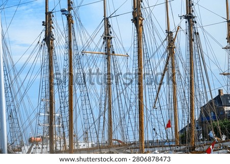 Traditional ship masts and rigging creating dense nautical patterns