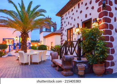 Traditional shops on street of Canarian village of Adeje at night, Tenerife, Spain - Powered by Shutterstock