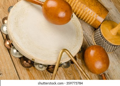 Traditional small percussion instruments in a still life on a rustic wooden surface