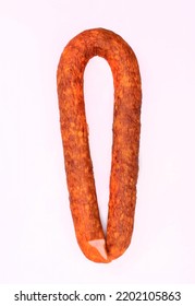 Traditional Smoked Pork Sausage, Long, Isolated. Polish Meat Sausage, Cold Cuts, A Packshot Photo For Package Design, Template. 