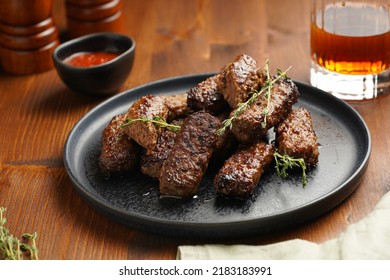 Traditional South European Skinless Sausages Cevapcici Made Of Ground Meat And Spices On Black Plate On Dark Wooden Board, With Thyme