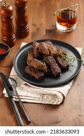 Traditional South European Skinless Sausages Cevapcici Made Of Ground Meat And Spices On Black Plate On Kitchen Towel With Thyme