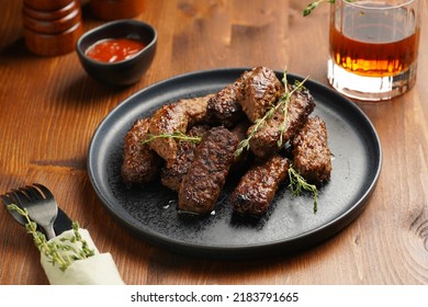 Traditional South European Skinless Sausages Cevapcici Made Of Ground Meat And Spices On Black Plate On Dark Wooden Board, With Thyme