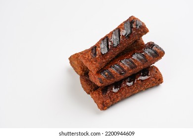 Traditional South European Skinless Sausages Cevapcici Made Of Ground Meat And Spices, Vegan Substitute Made Of Soy Protein, Stacked On White Background