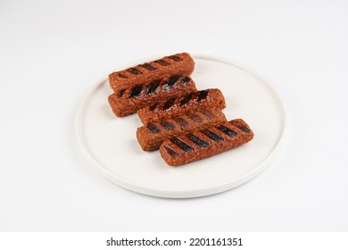 Traditional South European Skinless Sausages Cevapcici Made Of Ground Meat And Spices, Vegan Substitute Made Of Soy Protein, Five Pieces On White Plate On White Background