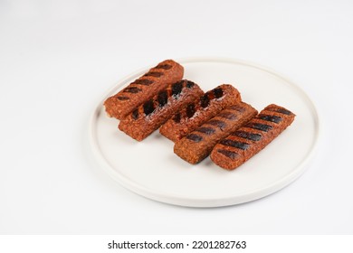 Traditional South European Skinless Sausages Cevapcici Made Of Ground Meat And Spices, Vegan Substitute Made Of Soy Protein, Five Pieces On White Plate On White Background