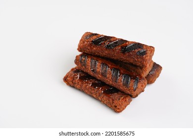 Traditional South European Skinless Sausages Cevapcici Made Of Ground Meat And Spices, Vegan Substitute Made Of Soy Protein, Stacked On White Background