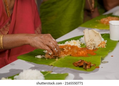 Traditional South Indian Food Served On Plantain Leaf. Rice, Vegetable Sambar, Pappadam, Vegetables, Etc., In Selective Focus.