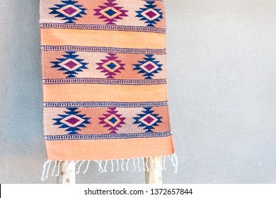 Traditional Southwestern Rug On Display By Adobe House Wall, Taos, New Mexico, USA