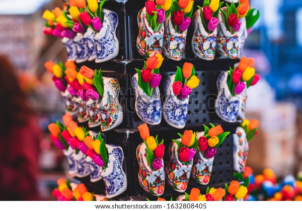 Traditional souvenirs from Amsterdam -\
fridge magnets, rows of Delftware porcelain, Dutch style houses,\
dutch wooden clogs, wooden tulips and windmill miniature, shop\
window store front,\
Netherlands\
