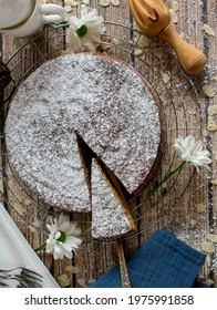 Traditional spanish almond cake Tarta de santiago fresh baked and served on a rustic wooden table background from above
