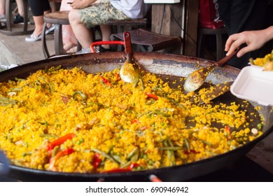 Traditional spanish cuisine - seafood paella with shrimps, mussels, fish, rice, lemon and herbs - Powered by Shutterstock