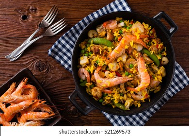 Traditional Spanish paella with seafood and chicken. Prepared in wook. Top view.