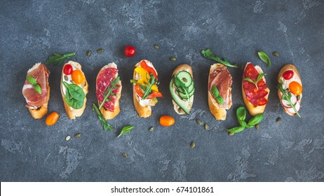 Traditional Spanish Tapas On Black Background. Flat Lay, Top View