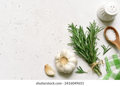 Traditional spices of mediterranean cuisine : sea salt, garlic,pepper, rosemary, sea salt and olive oli on a light slate, stone or concrete background . Top view with copy space. - Powered by Shutterstock