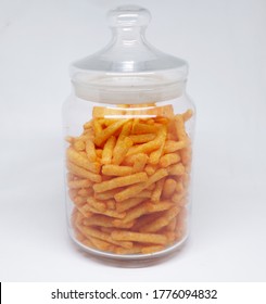  Traditional Spicy Snack, Stick Shape, Stick Balado,  Cheetos Taste Like, On Glass Jar White Background Isolated                              