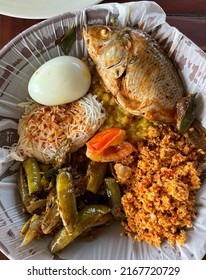 Traditional Sri Lankan Food On A Plate. Fish, Curry, Noodles, Rice, Beans, Egg And Vegetables