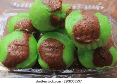 Traditional steamed cake from Indonesia in green with pandan leaves - Shutterstock ID 2208303537