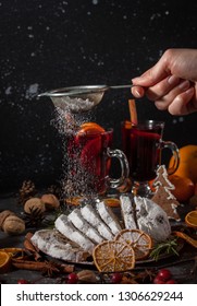 Traditional stollen cake and milled Hot wine with Christmas decorations background. Holiday dark photo.   - Shutterstock ID 1306629244