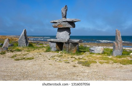 A traditional stone inukshuk, an Inuit cultural symbol used as a landmark to guide travelers in the far north.