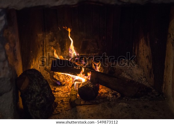 Traditional Stonemade Fireplace Burning Wood Mani Stock Photo