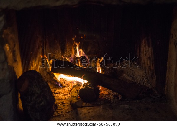 Traditional Stonemade Fireplace Burning Wood Mani Stock Photo