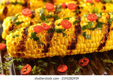 Traditional Street Food Grilled Corn Cob With Chilli Pepper And Cilantro Close Up.