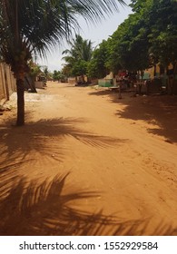 Traditional Street In Togo,  Africa. Red Dirt Road