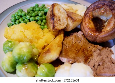 traditional sun day lunch, roast beef and green peas, home made Yorkshire pudding with gravy